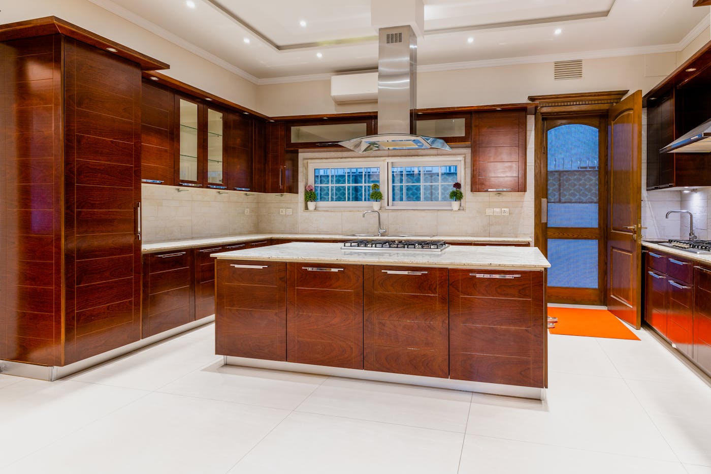 Modern kitchen with dark wood cabinets and marble countertops in a well-specified Sydney home