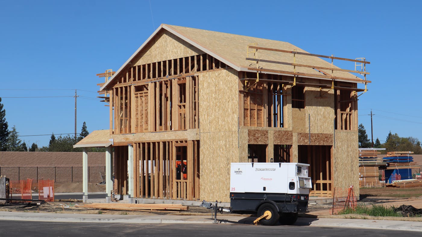New house under construction showing wooden framing and energy-efficient build materials