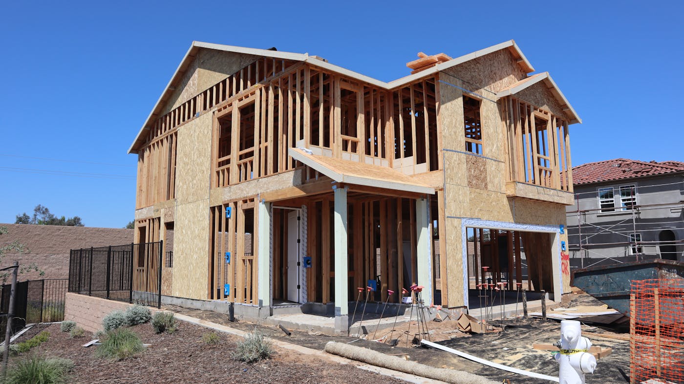 New suburban house under construction showing timber framing and development in progress