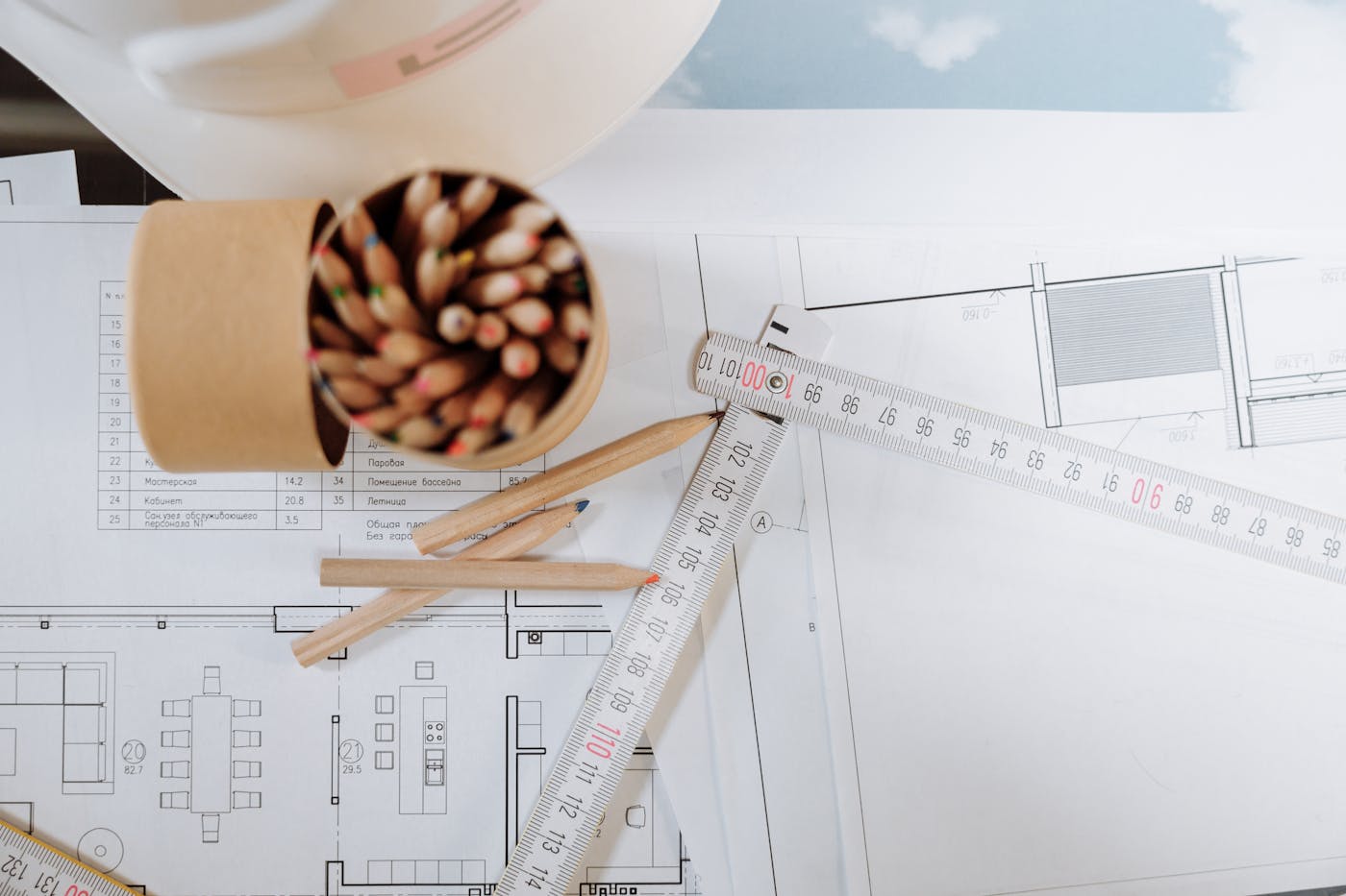 Architectural blueprints with pencils and ruler on a planning workspace