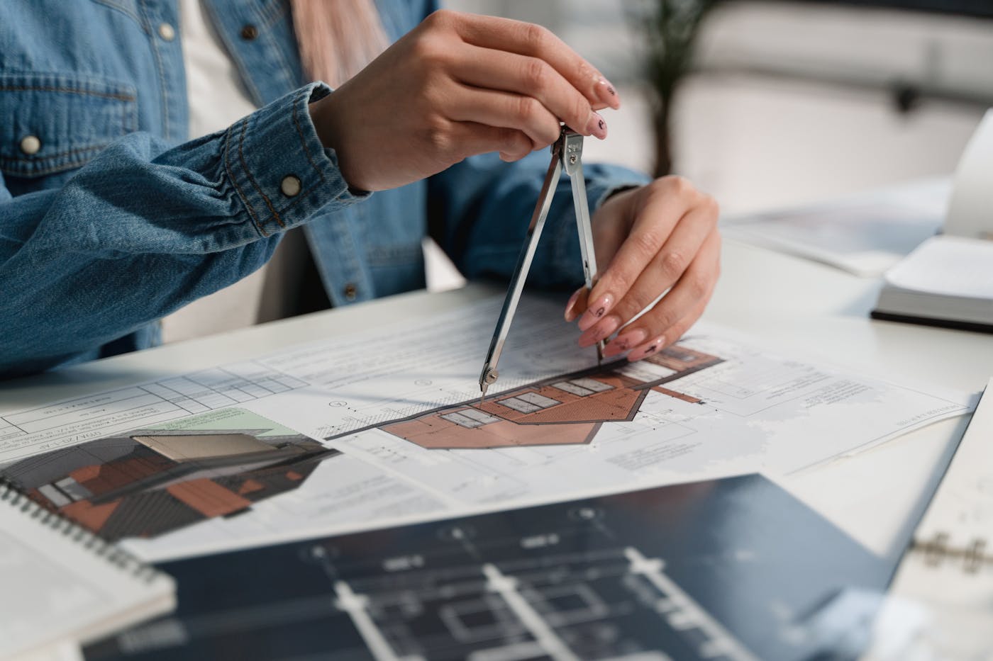 Building designer working with technical drawings and compass for a Sydney office renovation
