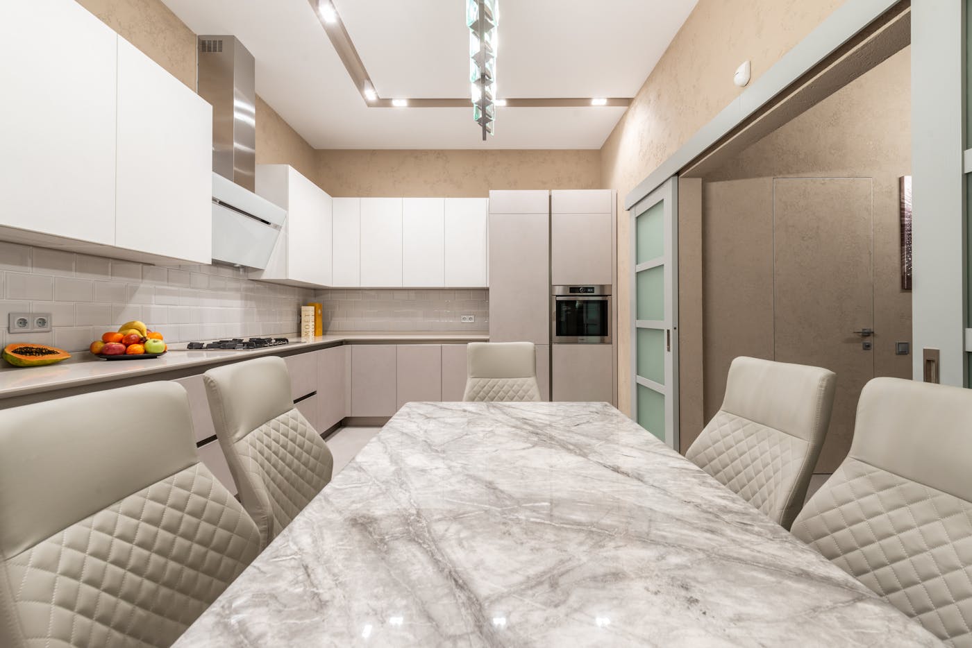 Contemporary kitchen with minimalist design and marble table in a Sydney custom home