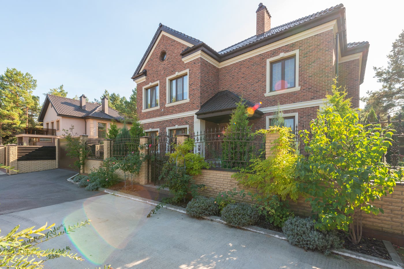 Elegant brick house with lush garden and driveway representing quality home building in Australia