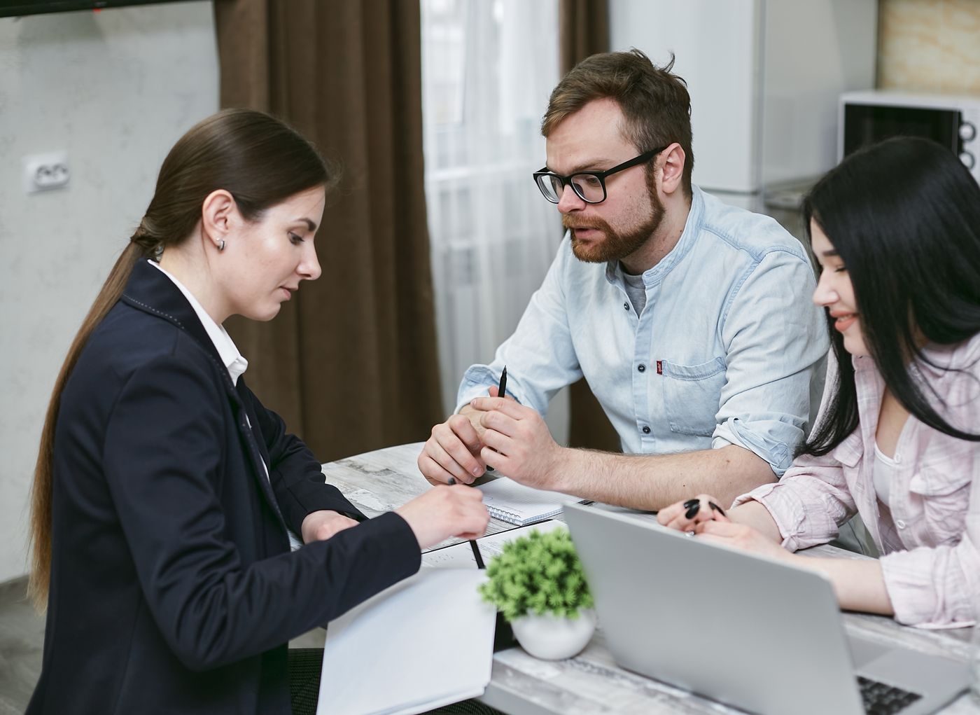 Homeowner reviewing a building contract with a builder before signing
