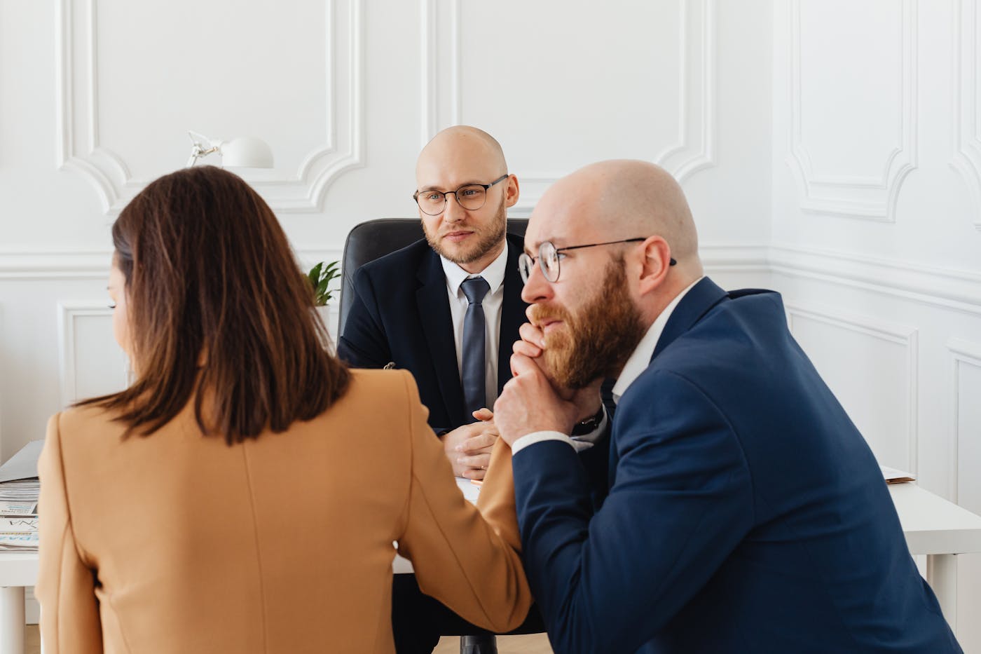 Consultant discussing townhouse development plans with clients in a modern Sydney office