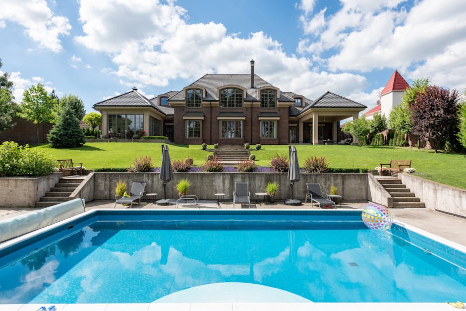 Luxury custom home exterior with pool and outdoor entertaining area showing indoor-outdoor living