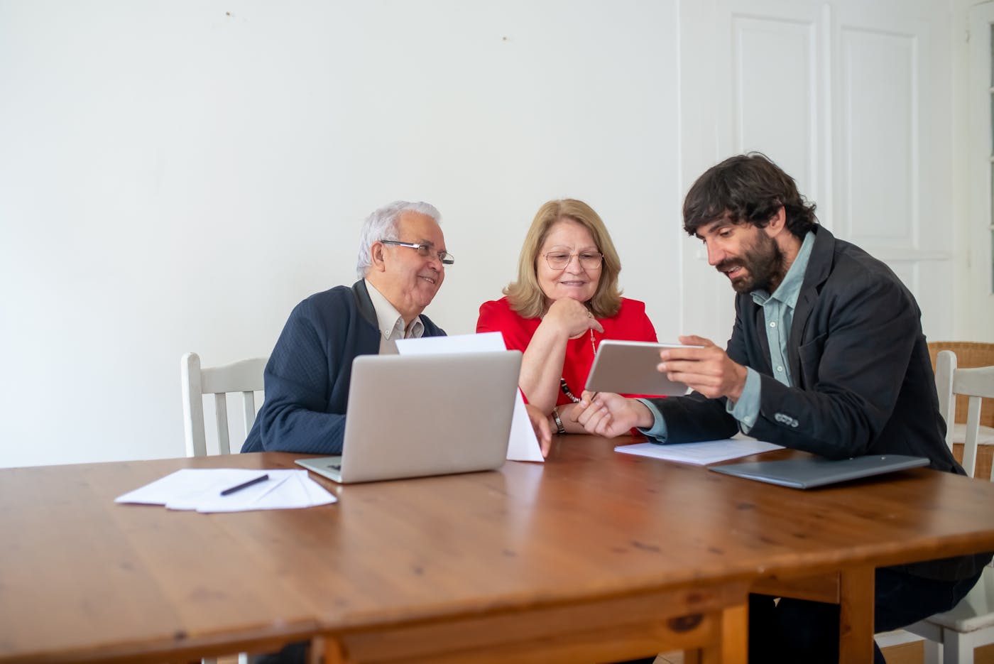 Consultant discussing building plans with clients in a modern office