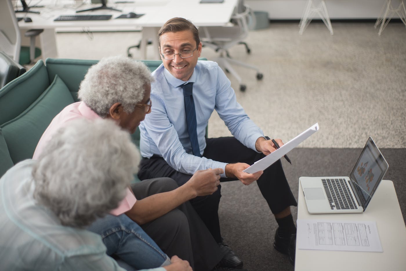Design consultant discussing home plans with clients in a modern Sydney office