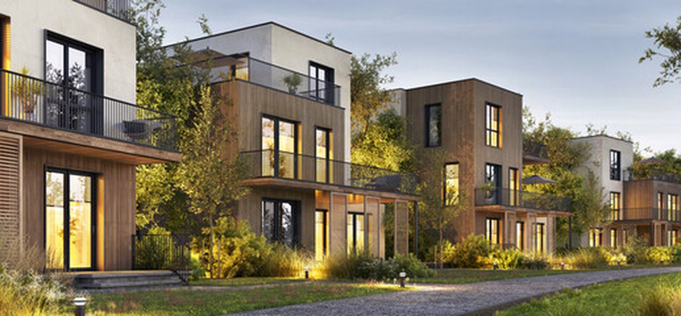 Row of modern timber-clad townhouses with landscaped gardens at dusk